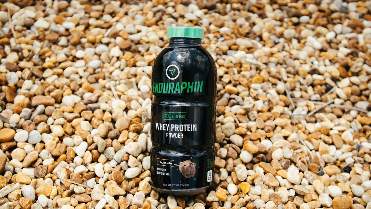 Enduraphin Whey Protein bottle in a field setting